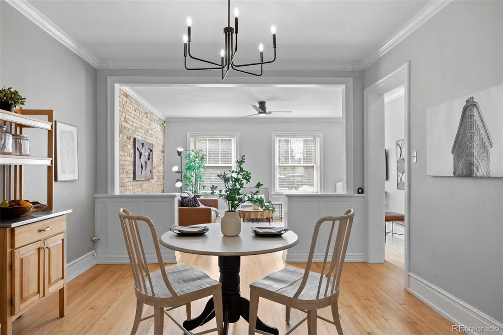 Dining room with a pendant light, looking through to the living room