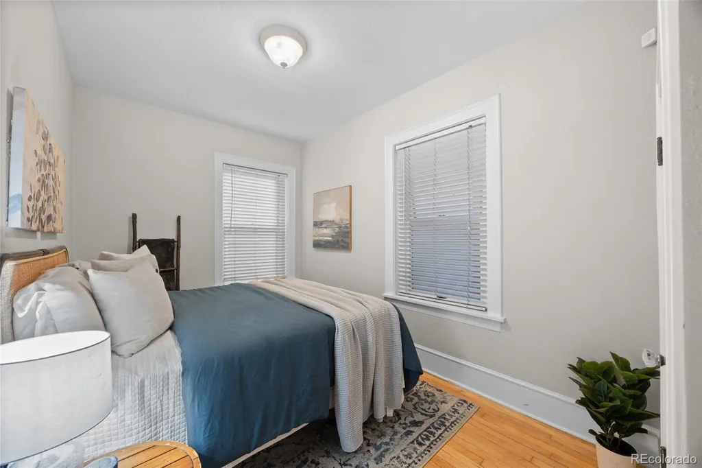 Bedroom with a window and hardwood floors