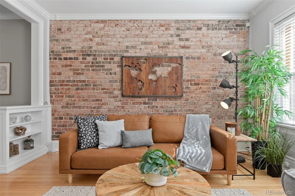 Sofa set against the original exposed brick wall beside a built-in shelf