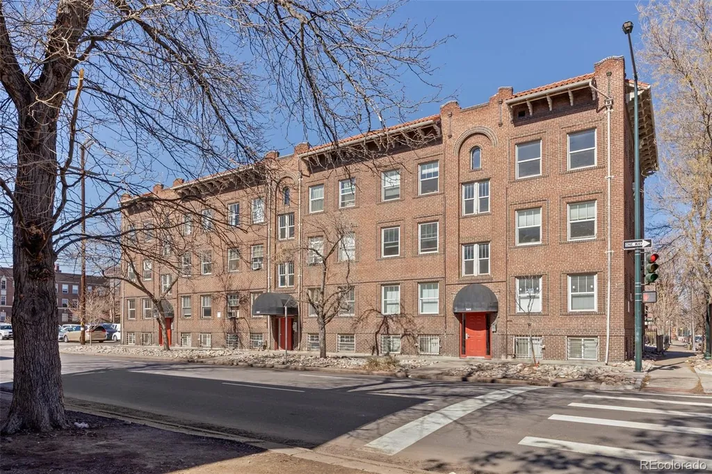 The brick building on a clear day, seen from the street