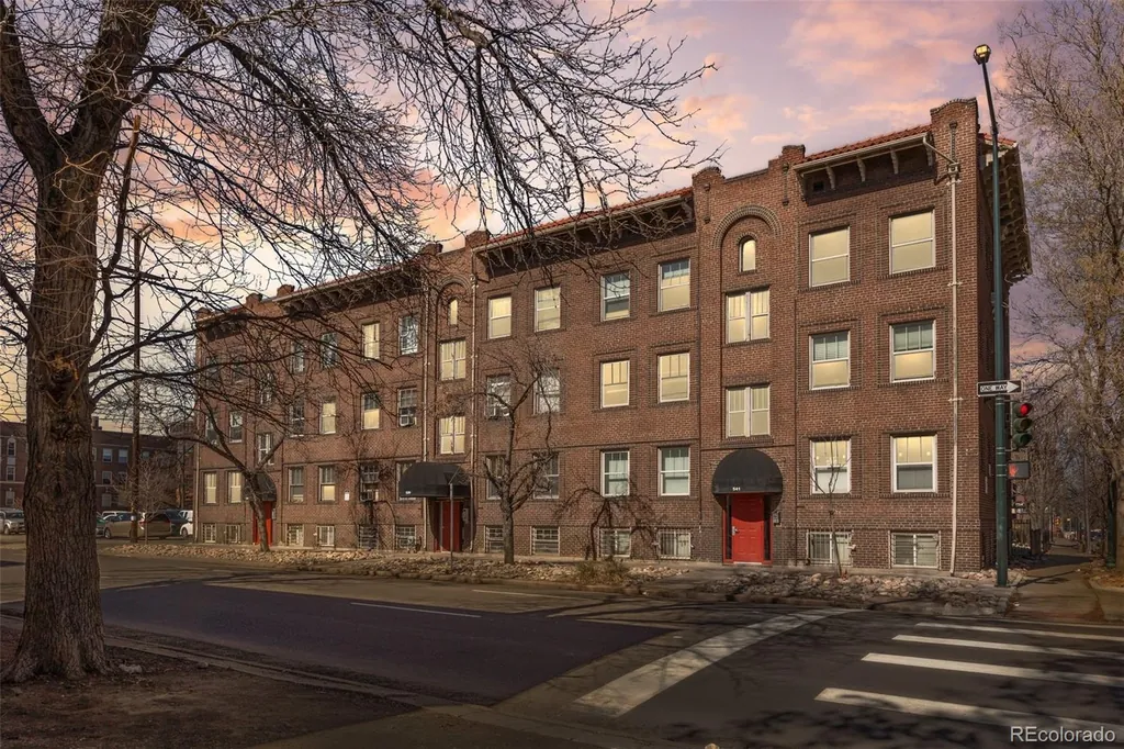 The brick building at dusk with lit windows